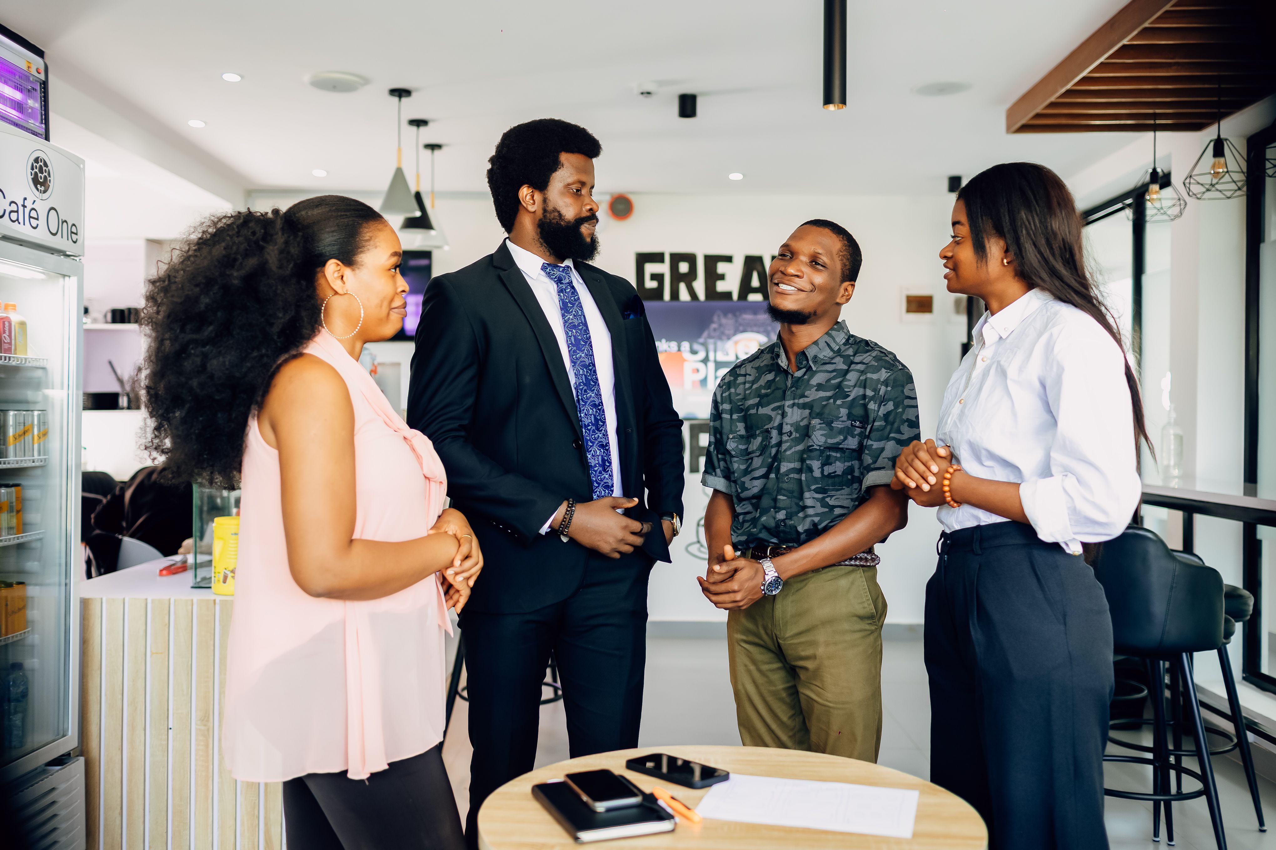 Nigerian professionals in a working conversation in a Lagos office