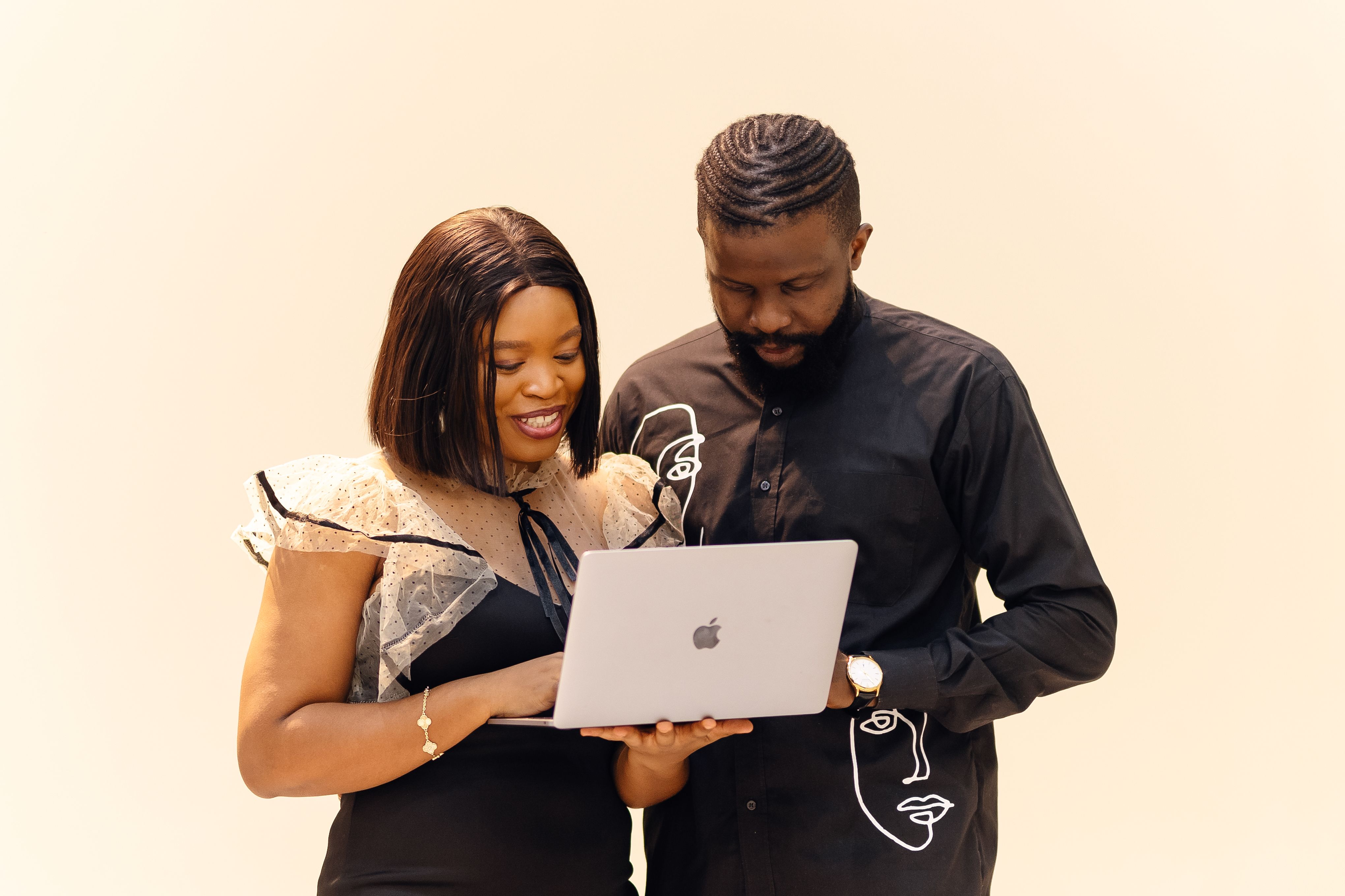Nigerian professionals collaborating around a laptop during a marketing work session